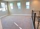 Bright and airy loft area with carpeted flooring and multiple windows at 9886 Belikove Manor Ave, Las Vegas, NV 89178