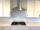 Stainless steel gas cooktop with white subway tile backsplash at 9886 Belikove Manor Ave, Las Vegas, NV 89178