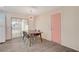 Dining area with a stylish table, four chairs, a statement light fixture and patio access at 2212 Kirk Ave, Las Vegas, NV 89101