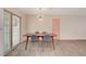 Dining area with a stylish table, four chairs, a statement light fixture and patio access at 2212 Kirk Ave, Las Vegas, NV 89101