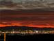 Stunning nighttime aerial view showcasing city lights and mountain backdrop at 270 Besame Ct, Las Vegas, NV 89138