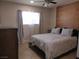 Bright bedroom with wood accent wall, ceiling fan, and tiled floor at 5900 Gordon Ave, Las Vegas, NV 89108