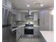 Modern kitchen with gray cabinets, quartz countertops, and stainless steel appliances at 5900 Gordon Ave, Las Vegas, NV 89108