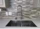 Modern kitchen sink with a pull-down faucet and stylish tile backsplash at 5900 Gordon Ave, Las Vegas, NV 89108