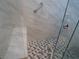 Modern shower with marble tile walls and hexagonal floor tile at 5900 Gordon Ave, Las Vegas, NV 89108