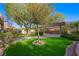 Backyard with putting green, mature landscaping, and covered structure with seating at 17 Winding Rd, Henderson, NV 89052