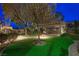 Night view of the backyard featuring a putting green, a seating area and lighted pergola at 17 Winding Rd, Henderson, NV 89052