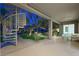 Covered outdoor patio with spiral staircase, landscaping and sitting area at 17 Winding Rd, Henderson, NV 89052