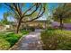 Landscaped backyard featuring a putting green, pergola, and seating area at 17 Winding Rd, Henderson, NV 89052