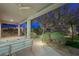 Covered backyard patio with a spiral staircase and cozy seating area offers picturesque outdoor retreat at 17 Winding Rd, Henderson, NV 89052