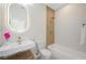 Modern bathroom featuring a floating vanity, illuminated mirror, and tiled shower-tub combination at 17 Winding Rd, Henderson, NV 89052