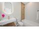 Modern bathroom featuring shower-tub combo, decorative accent wall, and illuminated mirror at 17 Winding Rd, Henderson, NV 89052