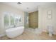Bathroom featuring a freestanding tub, a shower with glass doors, and natural light at 17 Winding Rd, Henderson, NV 89052
