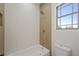 Modern bathroom showcasing a bathtub with stylish tile accents and a window at 17 Winding Rd, Henderson, NV 89052