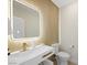 Stylish powder room featuring textured walls, a modern sink, sleek vanity and a lighted mirror at 17 Winding Rd, Henderson, NV 89052