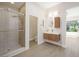 Well-lit bathroom with modern glass shower, sleek wood vanity and stylish fixtures at 17 Winding Rd, Henderson, NV 89052