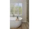 Freestanding soaking tub next to large window at 17 Winding Rd, Henderson, NV 89052