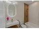 Modern bathroom featuring a backlit mirror, wood accents and a shower-tub combo at 17 Winding Rd, Henderson, NV 89052