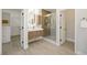 Modern bathroom featuring glass shower, wooden vanity and sleek lighting at 17 Winding Rd, Henderson, NV 89052