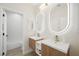 Bright bathroom showcasing a double sink vanity with illuminated mirrors and a separate tub at 17 Winding Rd, Henderson, NV 89052