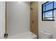 Modern bathroom featuring a shower-tub combo with herringbone tiling and wood accents at 17 Winding Rd, Henderson, NV 89052