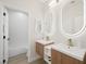 Modern bathroom features a double sink vanity and backlit mirrors at 17 Winding Rd, Henderson, NV 89052