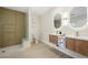 Bathroom featuring double sinks, modern mirrors, and a glass enclosed shower at 17 Winding Rd, Henderson, NV 89052