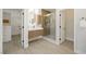 Bright bathroom featuring a glass shower, floating vanity, and a view into the adjacent walk-in closet at 17 Winding Rd, Henderson, NV 89052