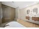 Modern bathroom with a large shower, double sink vanity, and sleek lighting fixtures at 17 Winding Rd, Henderson, NV 89052