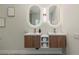 Bathroom vanity with dual sinks and oval shaped lighted mirrors at 17 Winding Rd, Henderson, NV 89052