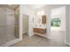Bright bathroom featuring a glass shower, floating vanity, and a view into the adjacent bedroom at 17 Winding Rd, Henderson, NV 89052