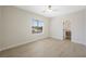 Bright bedroom features wood-look floors, modern ceiling fan, and an ensuite bathroom at 17 Winding Rd, Henderson, NV 89052