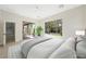 Bright bedroom with a large window and sliding glass door offering access to the landscaped backyard, complemented by a ceiling fan at 17 Winding Rd, Henderson, NV 89052