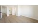 Bedroom with wood-look floors and access to walk-in closet and hallway at 17 Winding Rd, Henderson, NV 89052