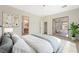 Bright bedroom with a large window and sliding glass door offering access to the landscaped backyard, complemented by a ceiling fan at 17 Winding Rd, Henderson, NV 89052