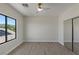 Bright bedroom boasts vinyl wood flooring, large window, and a mirrored closet at 17 Winding Rd, Henderson, NV 89052