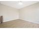 Minimalist bedroom featuring neutral walls, wood-look floors, and a modern floor lamp at 17 Winding Rd, Henderson, NV 89052