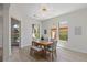 Bright dining room with hardwood floors, large windows, and a modern light fixture at 17 Winding Rd, Henderson, NV 89052