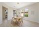 Dining room with natural lighting, modern light fixture, wood table and seating at 17 Winding Rd, Henderson, NV 89052