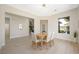 Bright dining room with modern light fixture and entryways to other areas of the home at 17 Winding Rd, Henderson, NV 89052
