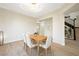 Open dining area featuring elegant chandelier, modern panel accent wall and seamless entry to hallway at 17 Winding Rd, Henderson, NV 89052