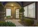 Welcoming entryway features a stylish front door, lush greenery, and comfortable seating area at 17 Winding Rd, Henderson, NV 89052