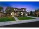 Stunning home exterior at dusk with manicured lawn, mature trees, and inviting entrance at 17 Winding Rd, Henderson, NV 89052
