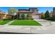 Beautiful home exterior with lush green lawn, landscaped yard, and spacious driveway, offering a picturesque setting at 17 Winding Rd, Henderson, NV 89052