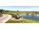Beautiful golf course with a pond, lush greenery, and a scenic view of the surrounding landscape at 17 Winding Rd, Henderson, NV 89052
