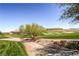 Scenic view of a golf course with mature tree, green fairways, sand traps, and clear blue sky at 17 Winding Rd, Henderson, NV 89052