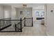 Open-concept hallway with modern black railing and fireplace sitting area at 17 Winding Rd, Henderson, NV 89052