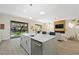 Bright, modern kitchen with marble island, stainless steel appliances, and view to a lovely backyard at 17 Winding Rd, Henderson, NV 89052