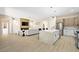 Open concept kitchen and living room featuring a large island, and modern fireplace at 17 Winding Rd, Henderson, NV 89052