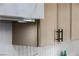 Contemporary kitchen cabinet with sleek, light-colored wood finish and modern black hardware at 17 Winding Rd, Henderson, NV 89052